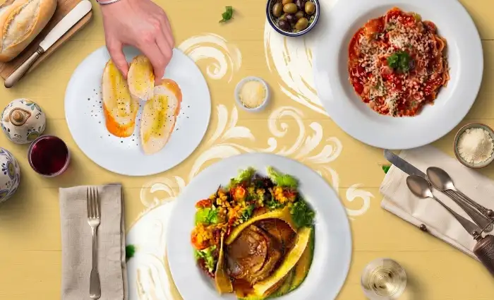 Mesa servida con platos gourmet, ensaladas, pasta y pan artesanal de Doña Dicha Bogotá.