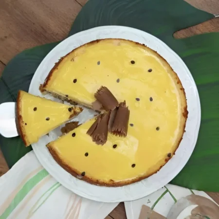Cheesecake artesanal de maracuyá con cobertura brillante.
